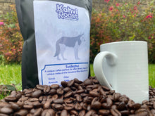 Load image into Gallery viewer, Bag of Susikahvi coffee beans from Kahvi Roast standing on freshly roasted beans