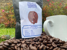Load image into Gallery viewer, Bag of Karhukahvi coffee beans from Kahvi Roast standing on freshly roasted beans