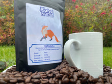 Load image into Gallery viewer, Bag of Kettukahvi coffee beans from Kahvi Roast standing on freshly roasted beans